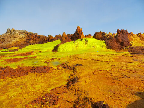 Surreal red green and yellow mineral formation at Danakil Depression with strong colours in Ethiopia, Africa; looking like planet Mars