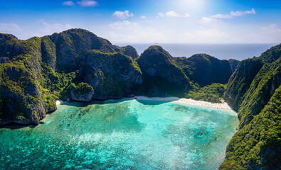 Aerial view of the famous Maya Beach, Phi Phi islands, Thailand, with turquoise sea shining between the lush mountains