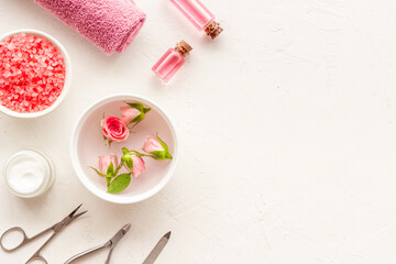 Hands and nail care cosmetic set with pink roses flowers.
