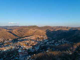 A beautiful aerial view of the endless mountains around the Mexican city of Guanajuato at sunset.
