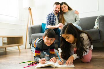 Young kids siblings coloring together