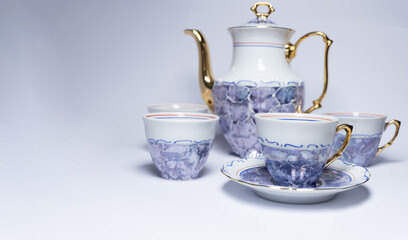 Old porcelain cups and kettle for tea or coffee isolated on white background. Banner for website with coffee, tea, food, drinks.