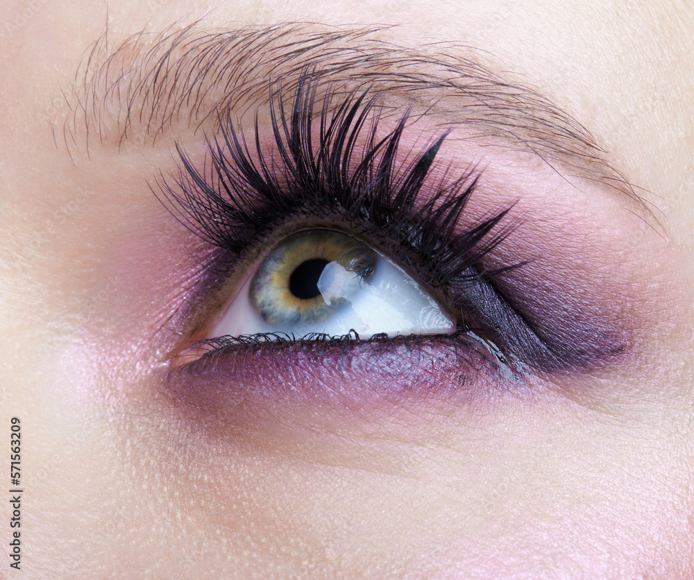 Wall mural closeup macro shot of human female eye. woman with lilac beauty eyes makeup.