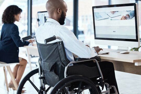 Wheelchair, office and black man disability in the workplace doing business analyst work. Working, computer and desk job of a disabled worker back planning a digital strategy for inclusive job