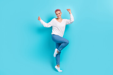 Fototapeta na wymiar Full body size photo cadre of dancing overjoyed girl have fun pink dyed hairstyle funky person wear denim jeans isolated on cyan color background