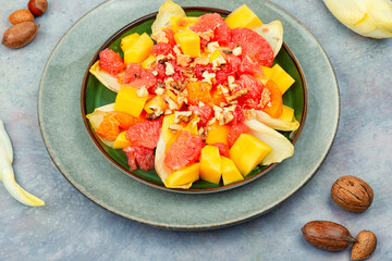 Fruit salad of citrus, chicory and nuts.