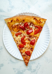 Slice of pizza with tomatoes