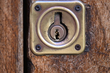 An old, traditional door locker in an entrance door in Spain.