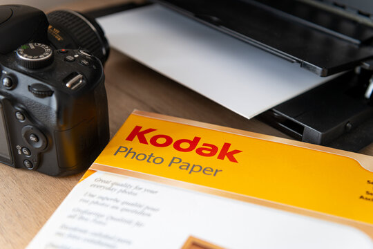 London. UK-02.12.2023. A packet of Kadak photo paper on a desk next to a printer and a camera.