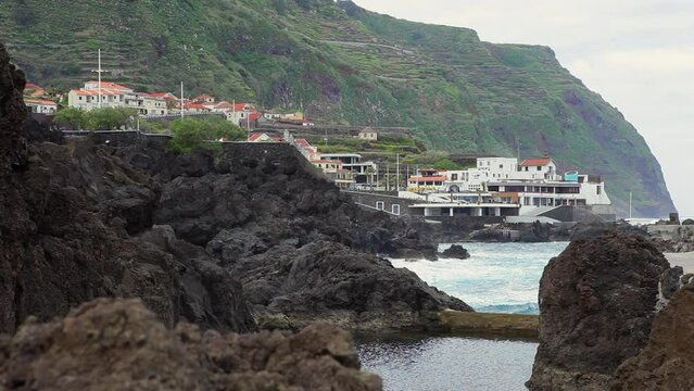 natural pool between the stones on the coast of the Atlantic on the island of Madeira on a cloudy day in summer