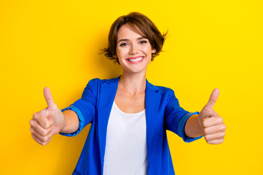 Photo of cheerful hr manager girl wear blue blazer double thumbs up like you select best option candidate isolated on yellow color background