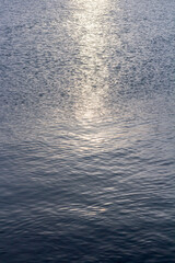 Obraz premium Detail of a sunlight reflecting in glittering sea. sparkler in water - background. sea water with sun glare and ripple. Powerful and peaceful nature concept.