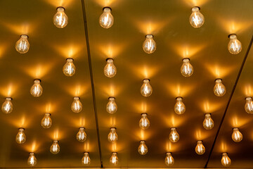 Working vintage style light bulbs on the ceiling background. Rows of theater lightbulbs on the outside entrance of an old cinema.