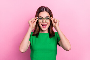 Photo of adorable astonished lady hands touch glasses open mouth isolated on pink color background