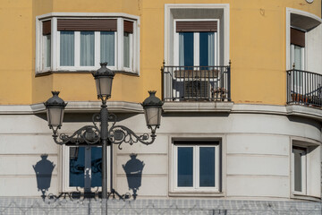Old city light in front of the residential building on the streets of Madrid, Spain. 