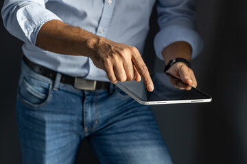 Closeup of a black businessman holding a tablet