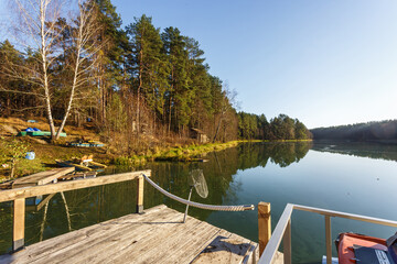 Obraz premium wooden house with piers on the lake. a place to relax from the hustle and bustle of the city