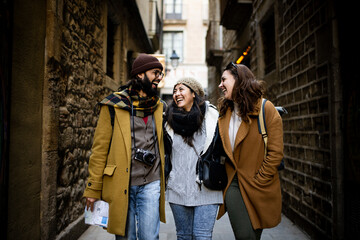 Cheerful multi-ethinc group of friends tourists having fun and walking on the streets of Barcelona - Travel, holidays and friendship concept