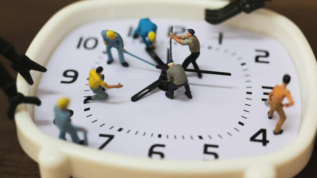 Miniature people : The team is working on an alarm clocks 