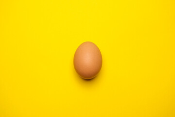 Egg on a yellow background. Cool minimal flat lay, copy space.