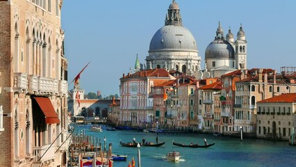 Grand Canal in Venice with Gondolas crossing the water and Cathedral Santa Maria della Salute.