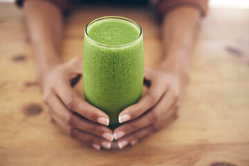 Hands, glass and smoothie with a black woman holding a health beverage for a weight loss diet or...