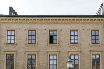 Facade of a vintage luxury Scandinavia apartment building with an open window