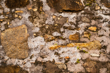 Ancient stone wall fragment. Abstract weathered background.