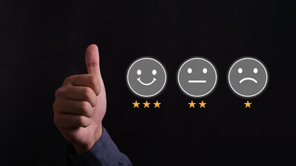 Business people or customers show satisfaction through the application on the laptop screen. By giving the most or the best satisfaction rating.Customer service satisfaction survey concept