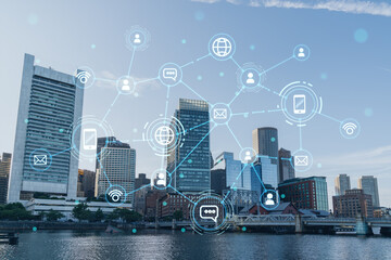 Panorama city view of Boston Harbor at day time, Massachusetts. Buildings of financial downtown. Glowing Social media icons. The concept of networking and establishing new connections between people