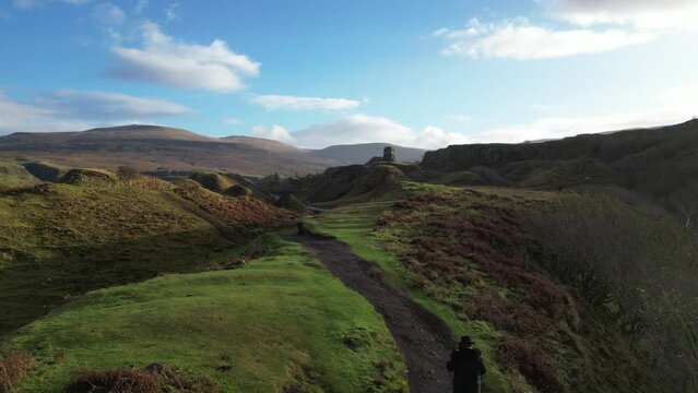 Isle of Skye fairy glen with man walking
