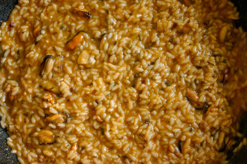 Close-up shot of a risotto with mussels, a typical dish of Italian cuisine