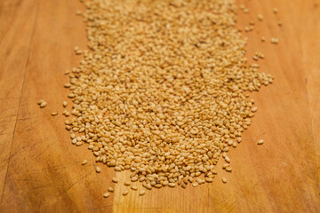 Organic sesame seeds isolated on a wooden cutting board