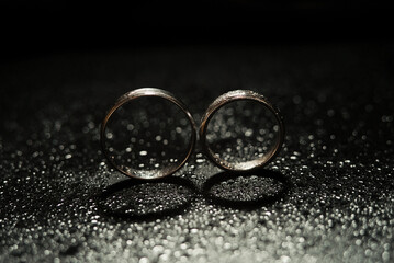 Obraz na płótnie Canvas Detailed gold wedding ring on beautiful raindrops background