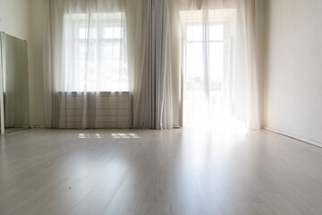 Fototapeta premium large bright room with window and curtains in the apartment
