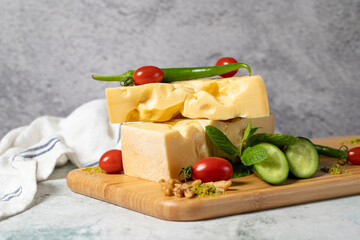 Gruyere cheese. Piece of Gruyere cheese on wooden cutting board. Cheese collection