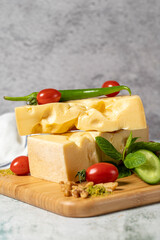 Gruyere cheese. Piece of Gruyere cheese on wooden cutting board. Cheese collection