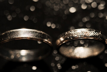 Detailed gold wedding ring on beautiful raindrops background