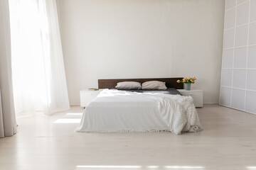 Fototapeta na wymiar Double bed in bright bedroom room interior furnishing furniture