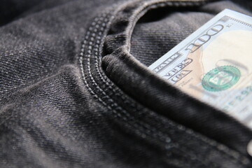 American dollars USD banknotes in jeans pocket.