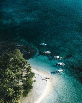 Aerial view of a many Catamaran boats along Coron Island coastline, Bayan ng Coron, Palawan, Philippines.