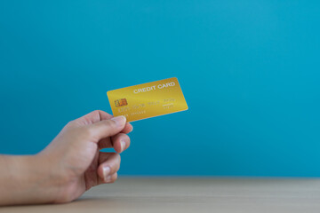 Female hands with credit cards on color background. Bank credit card with online service.