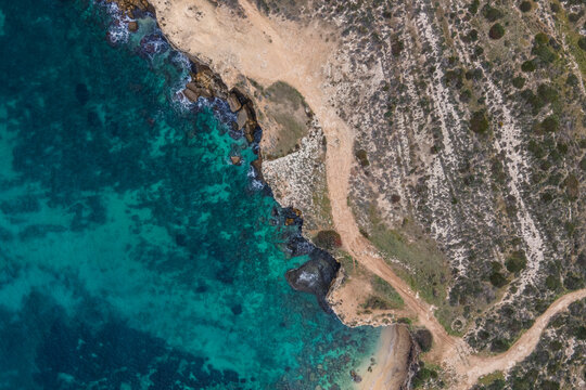 Aerial view of Punta della Mola coastline on Plemmirio Natural Reserve in Syracuse, Sicily, Italy.