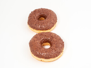 Chocolate donut with chocolate chips on a white background. close-up.