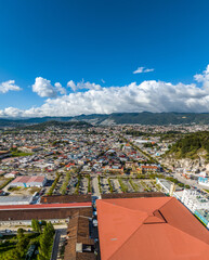 Aerial view of colorful mountain village of San Cristobal de Las Casas in Mexico. Clouds over the...