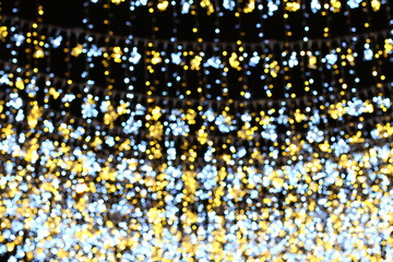 Abstract Christmas background. Blurred bokeh lights on black background.