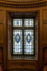 Stained glass window in wooden alcove of vintage building