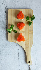 Red caviar canapes in the shape of the heart, tasty healthy food