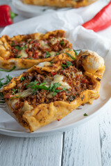 Turkish pide with minced meat, vegetables and cheese
