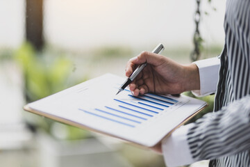 Financial consultant businesswoman analyzing charts in company financial report, Analyze investment planning, finance and accounting.